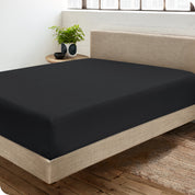 A sateen fitted sheet on a bed