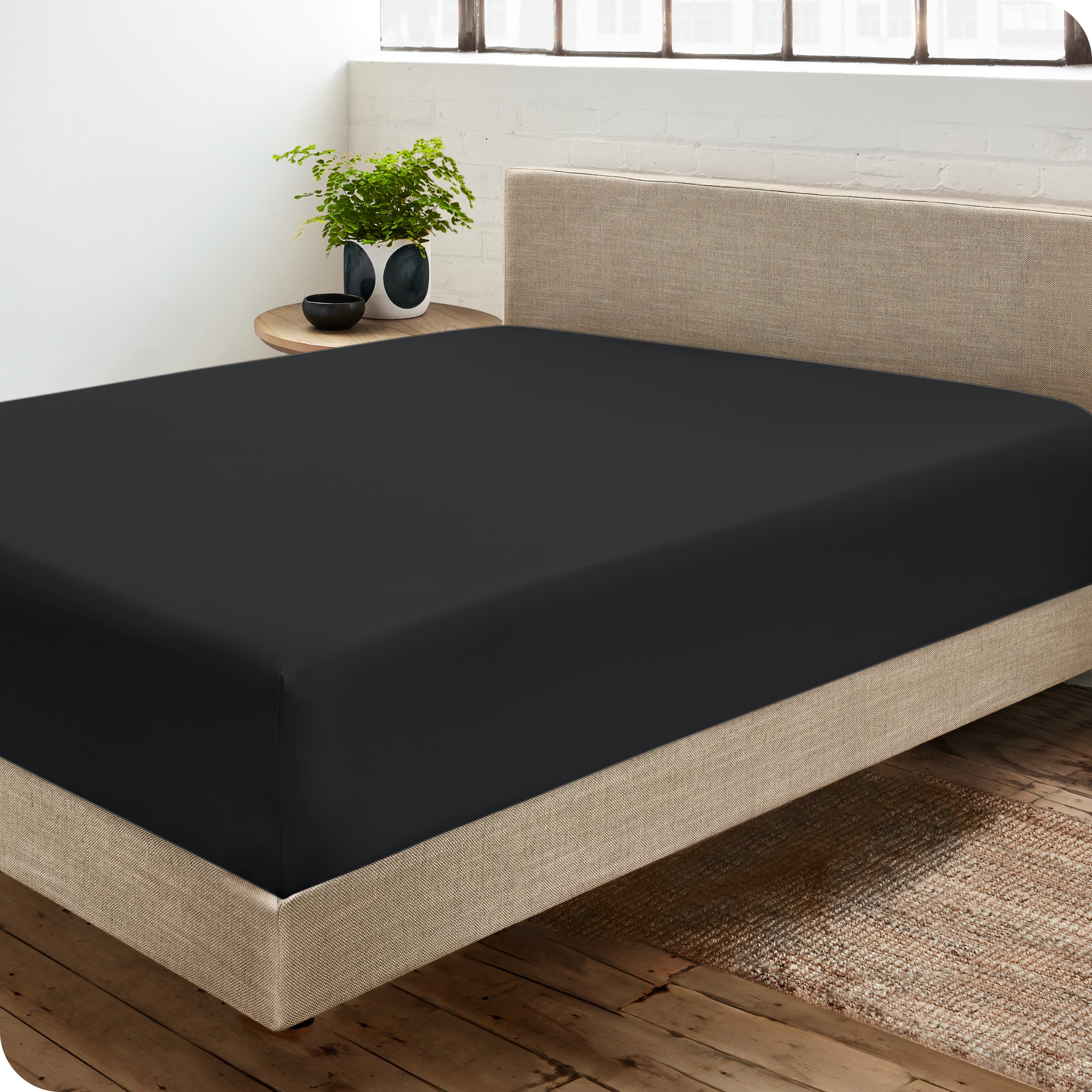 A sateen fitted sheet on a bed