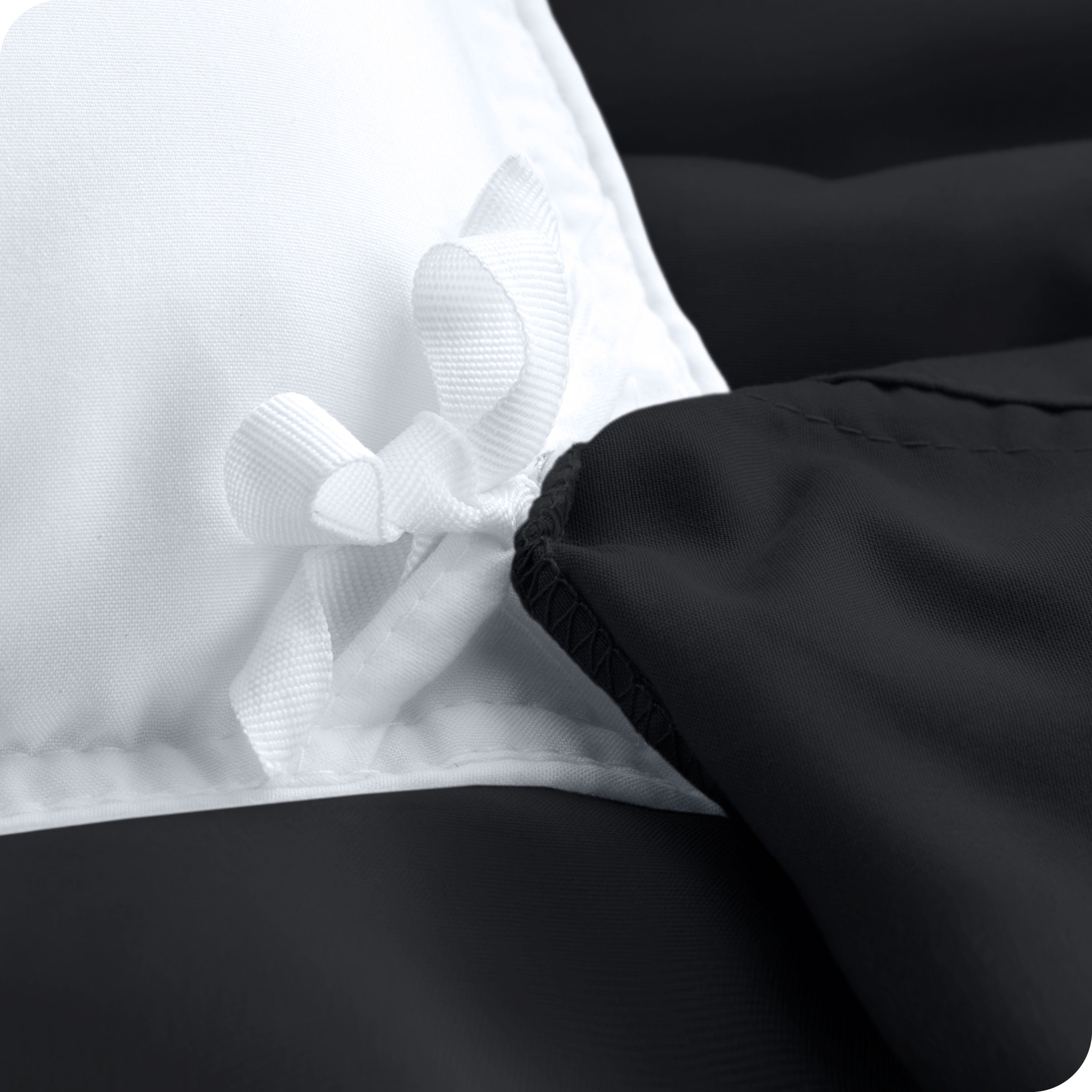 The corner ties of a duvet cover attached to a duvet insert