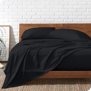 Organic jersey sheets on a bed with a wooden bed frame