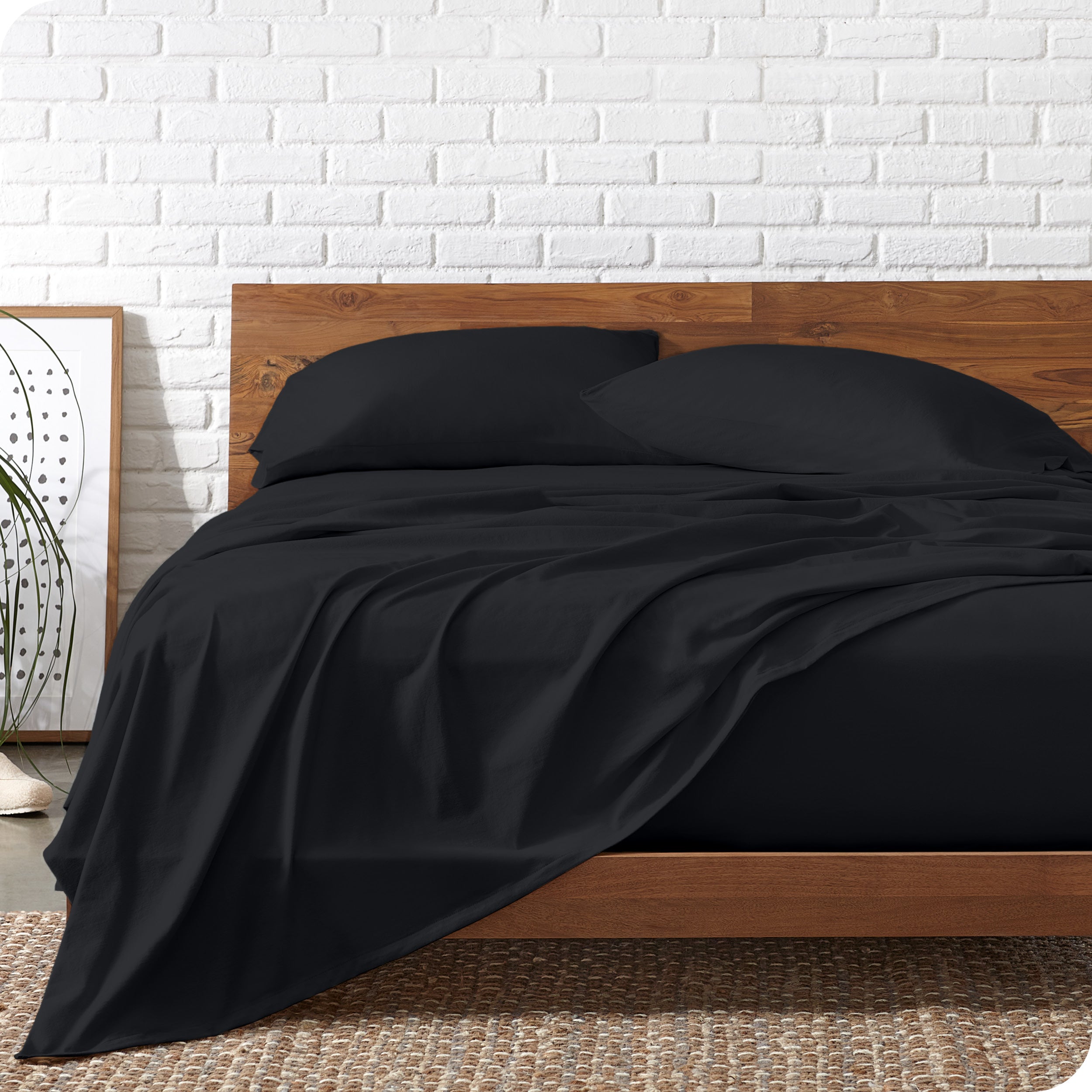 Organic jersey sheets on a bed with a wooden bed frame