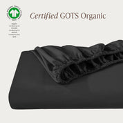 A single fitted sheet folded neatly showing part of the elastic. The fitted sheet is Certified GOTS Organic.