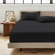 Percale fitted sheet on a mattress with matching pillowcases on pillows