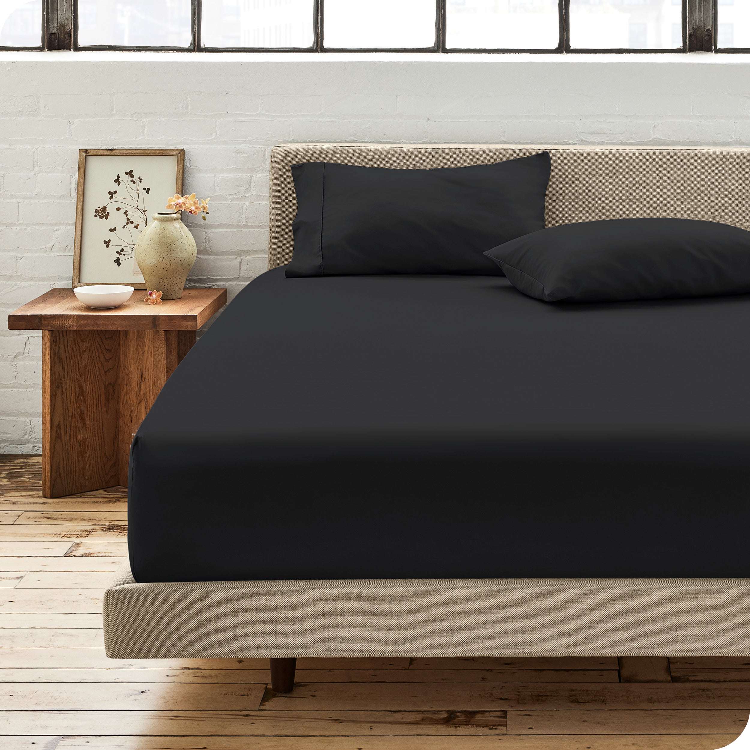 Percale fitted sheet on a mattress with matching pillowcases on pillows