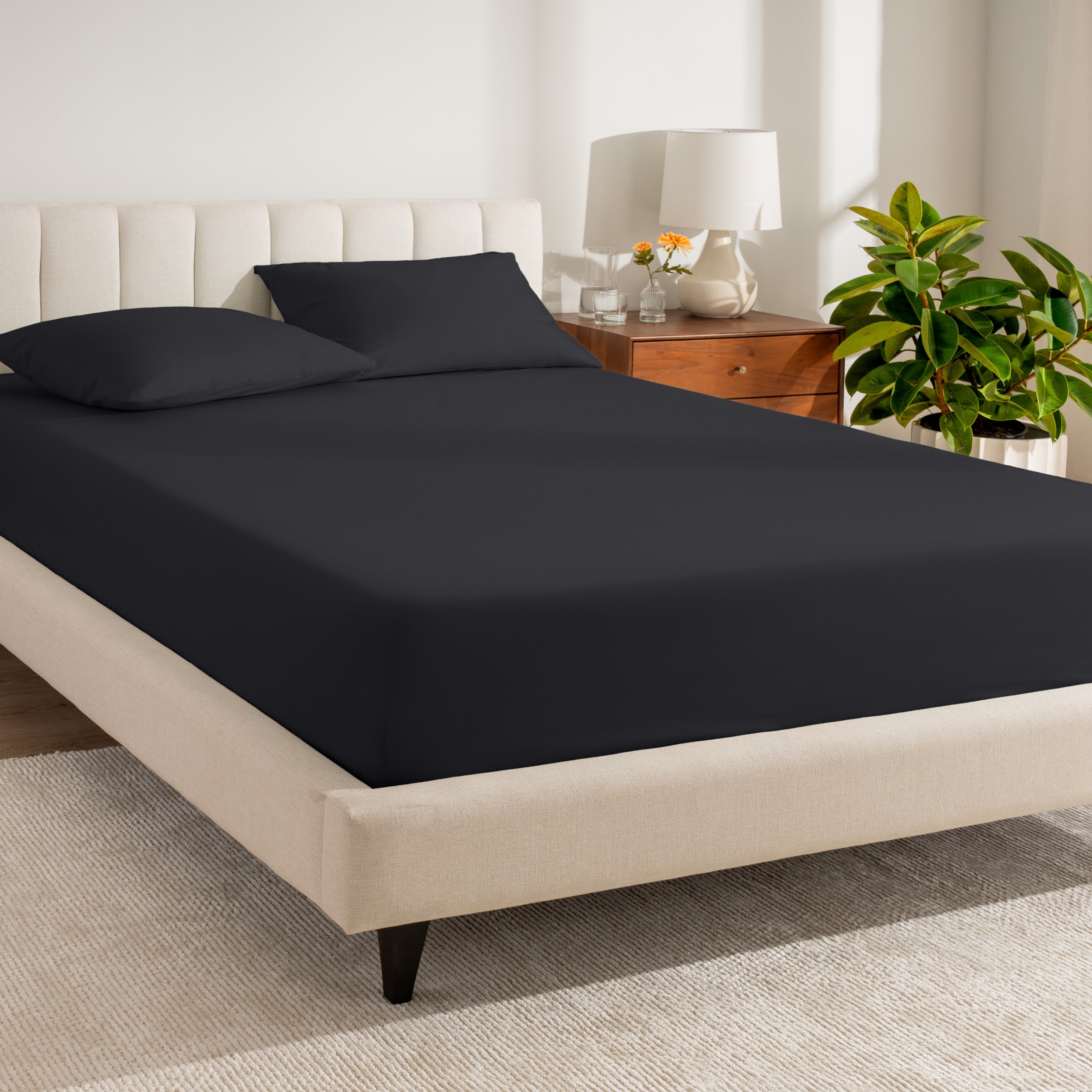 A single organic cotton percale fitted sheet on a bed