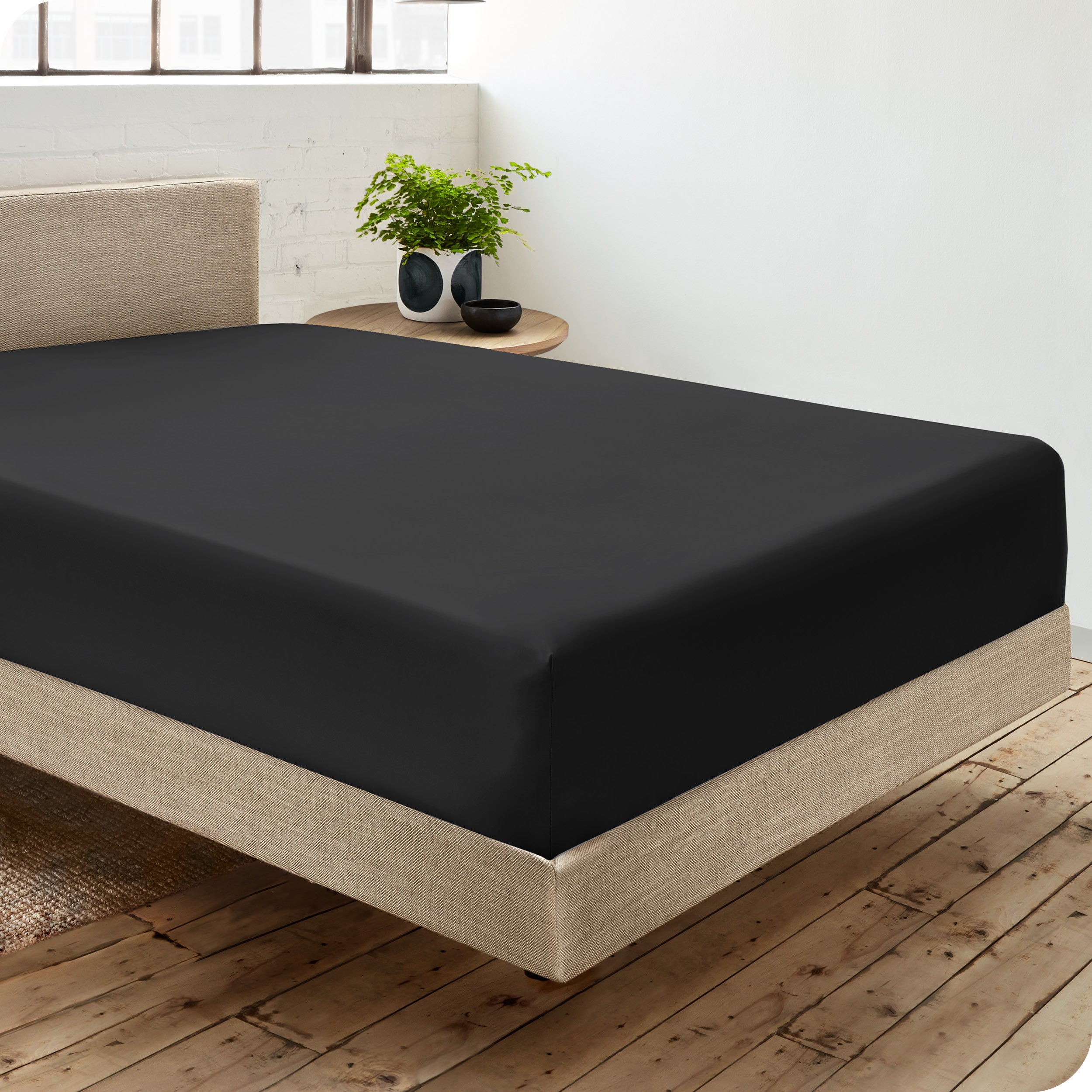 A single organic cotton fitted sheet on a bed