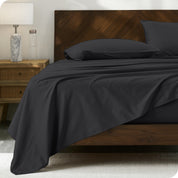 Percale sheet set on a bed with a wooden headboard