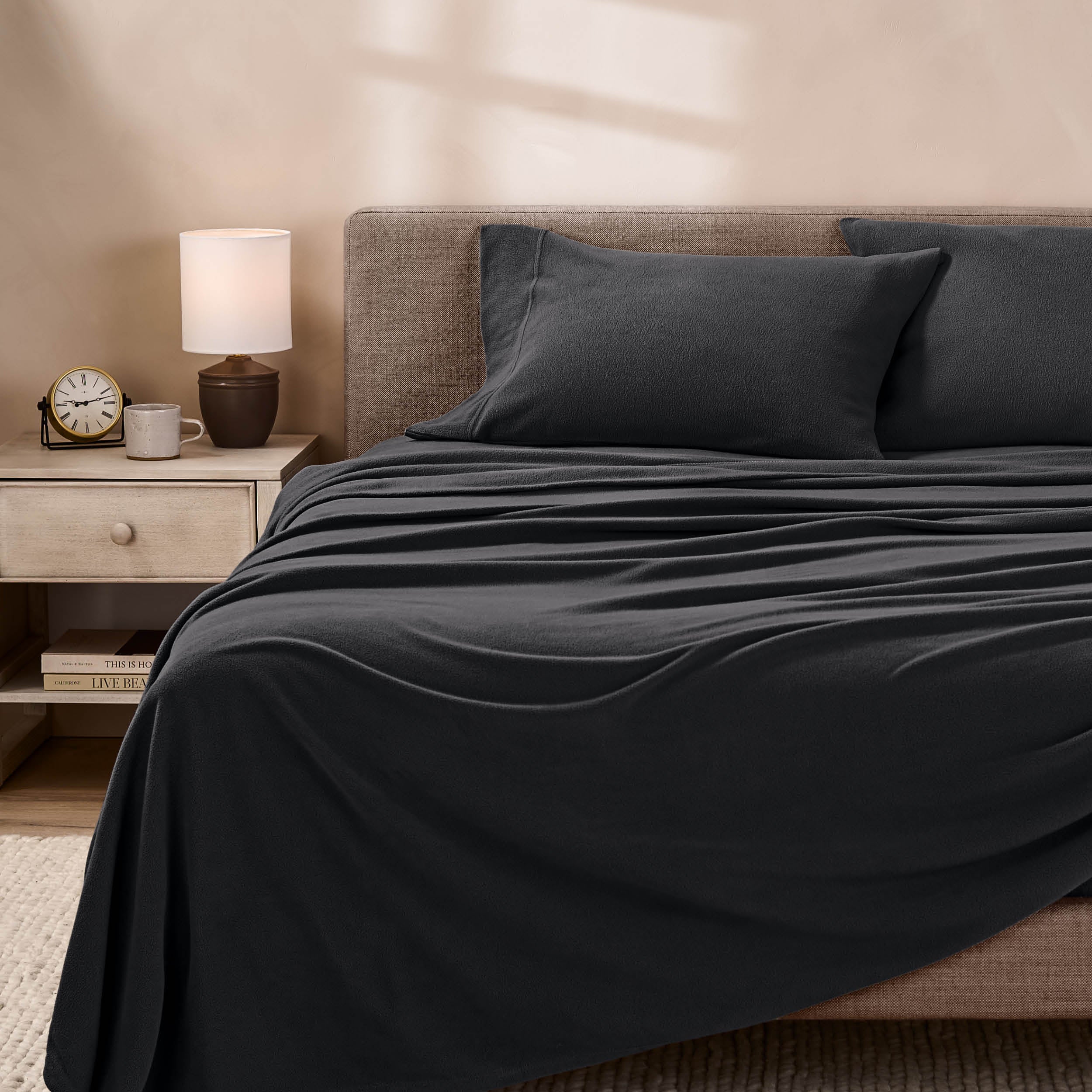 View of fleece sheets from the end of a bed with the top sheet draped over the side and end