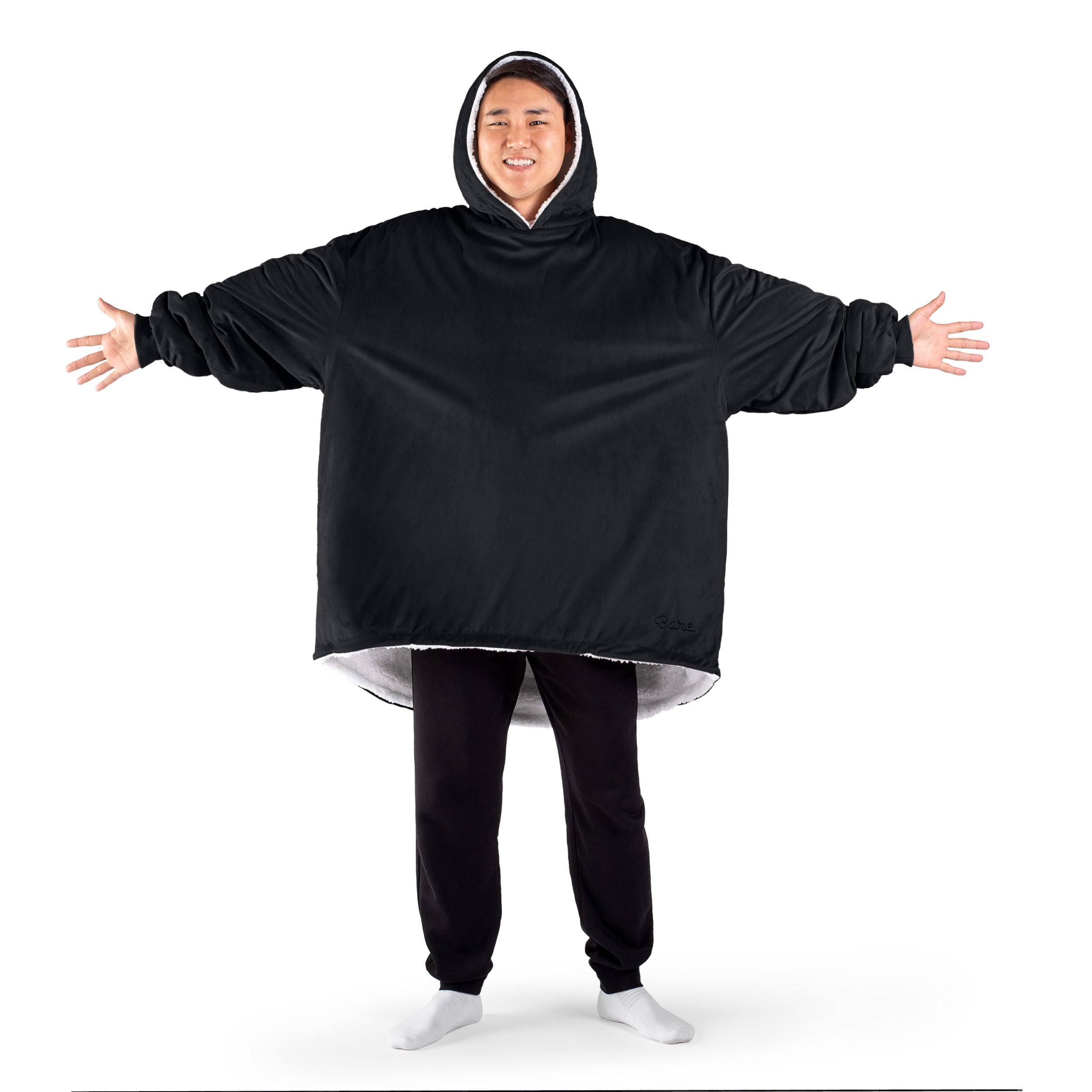 An adult with a sherpa wearable blanket on