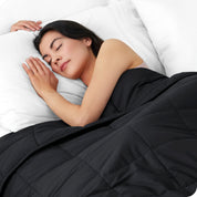 A woman sleeping with a weighted blanket over her body