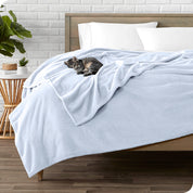 Microplush blanket laid out over a bed and folded back over itself