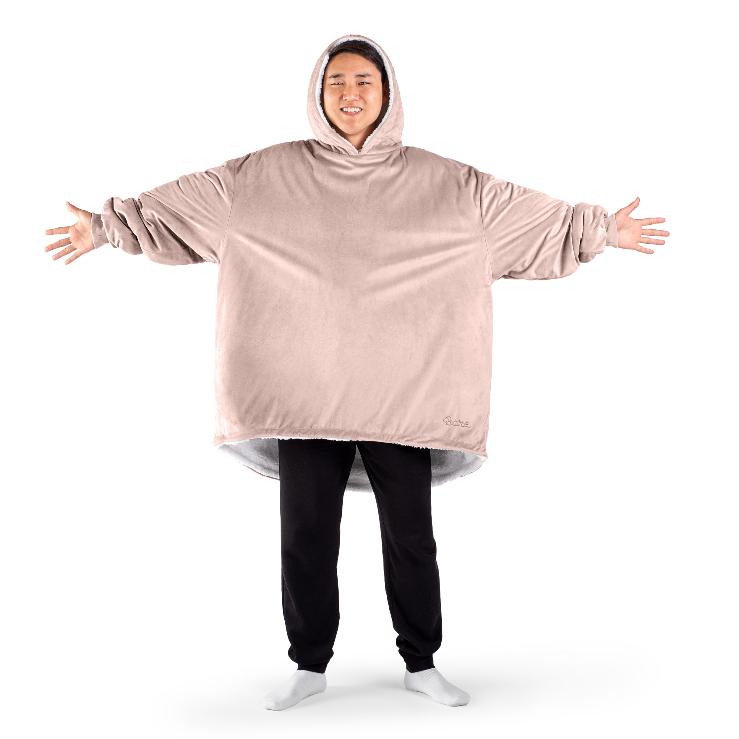 An adult with a sherpa wearable blanket on