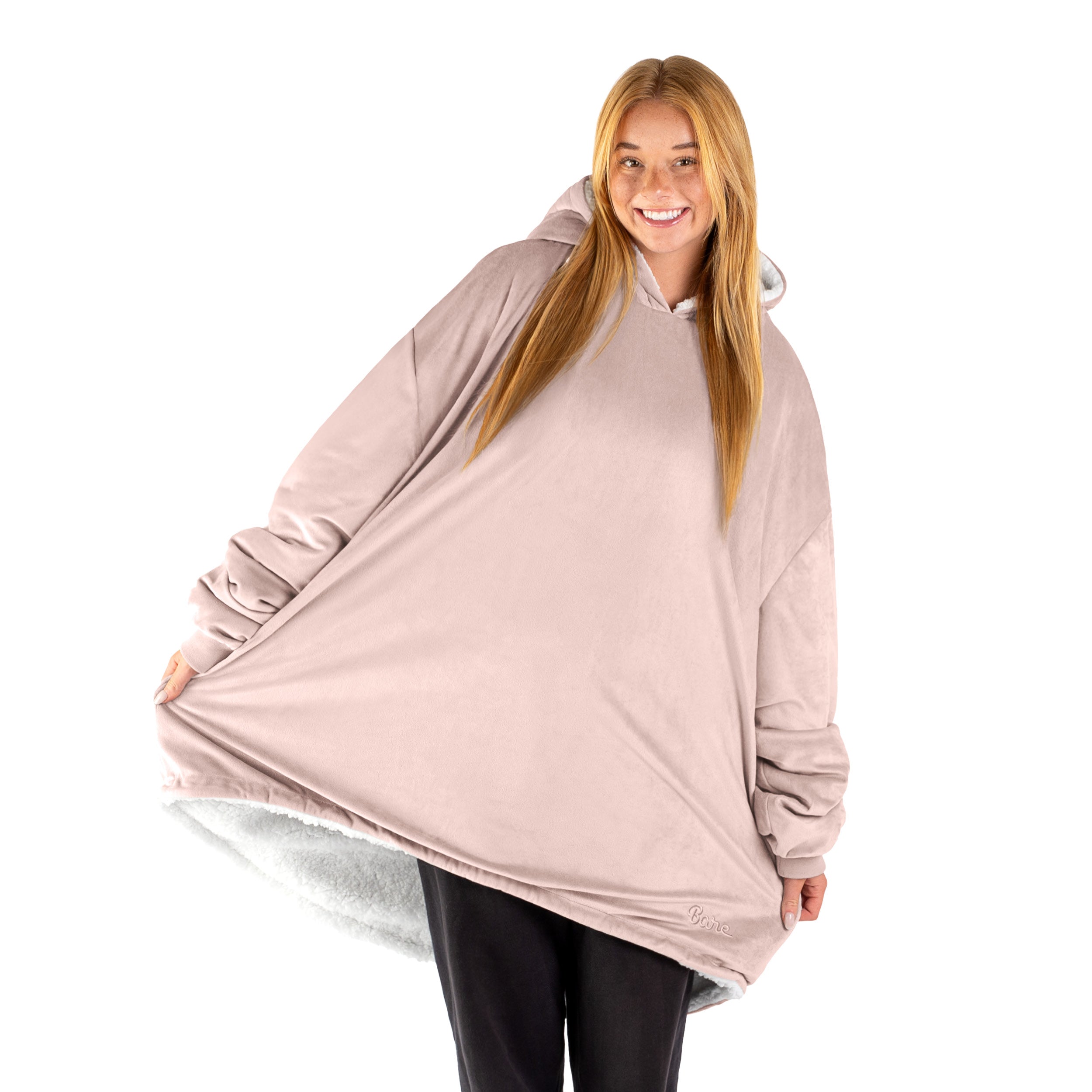 An adult with a sherpa wearable blanket on