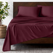 Wooden bed frame with bamboo sheets on the bed