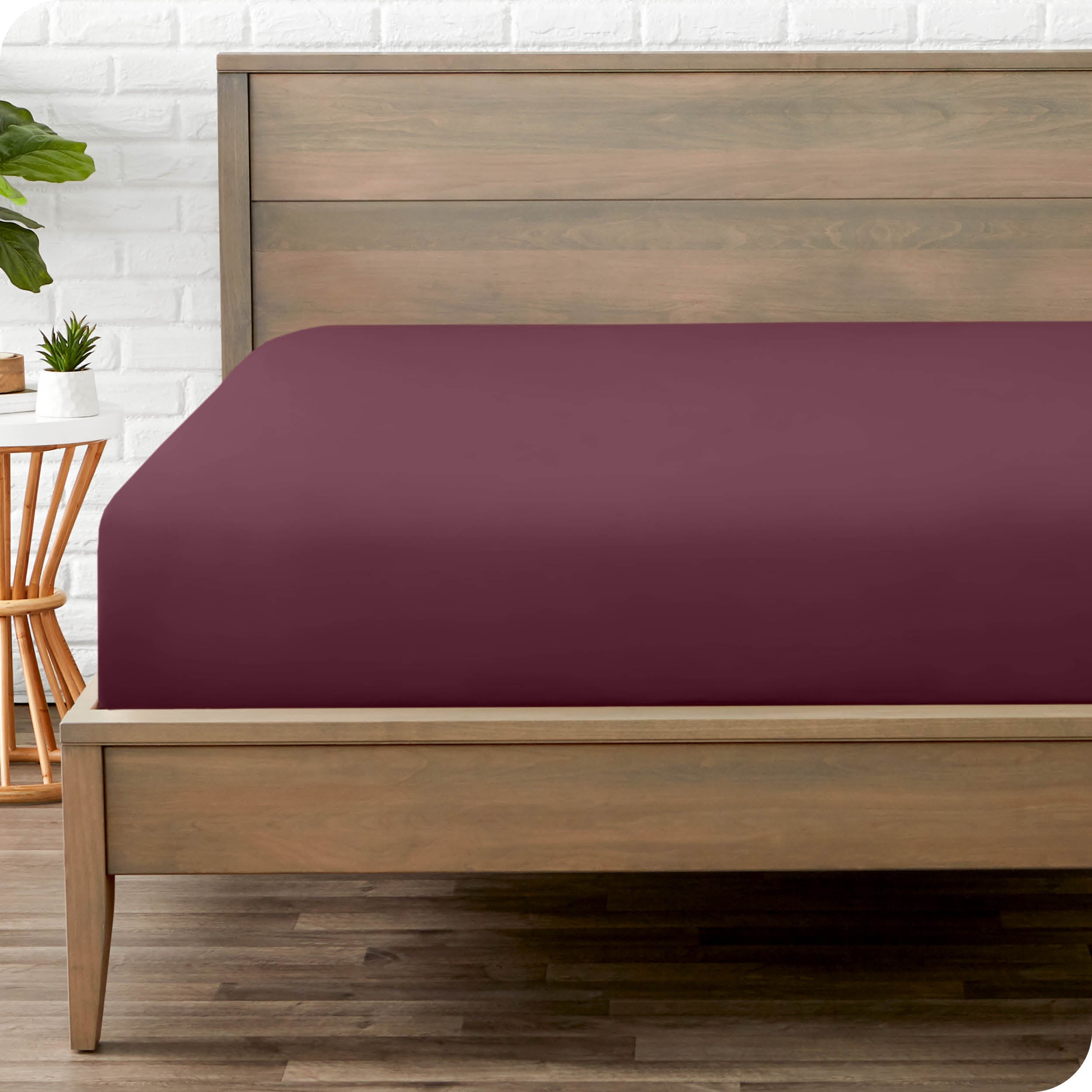End of bed view with fitted sheet made on the mattress of a modern bed. 