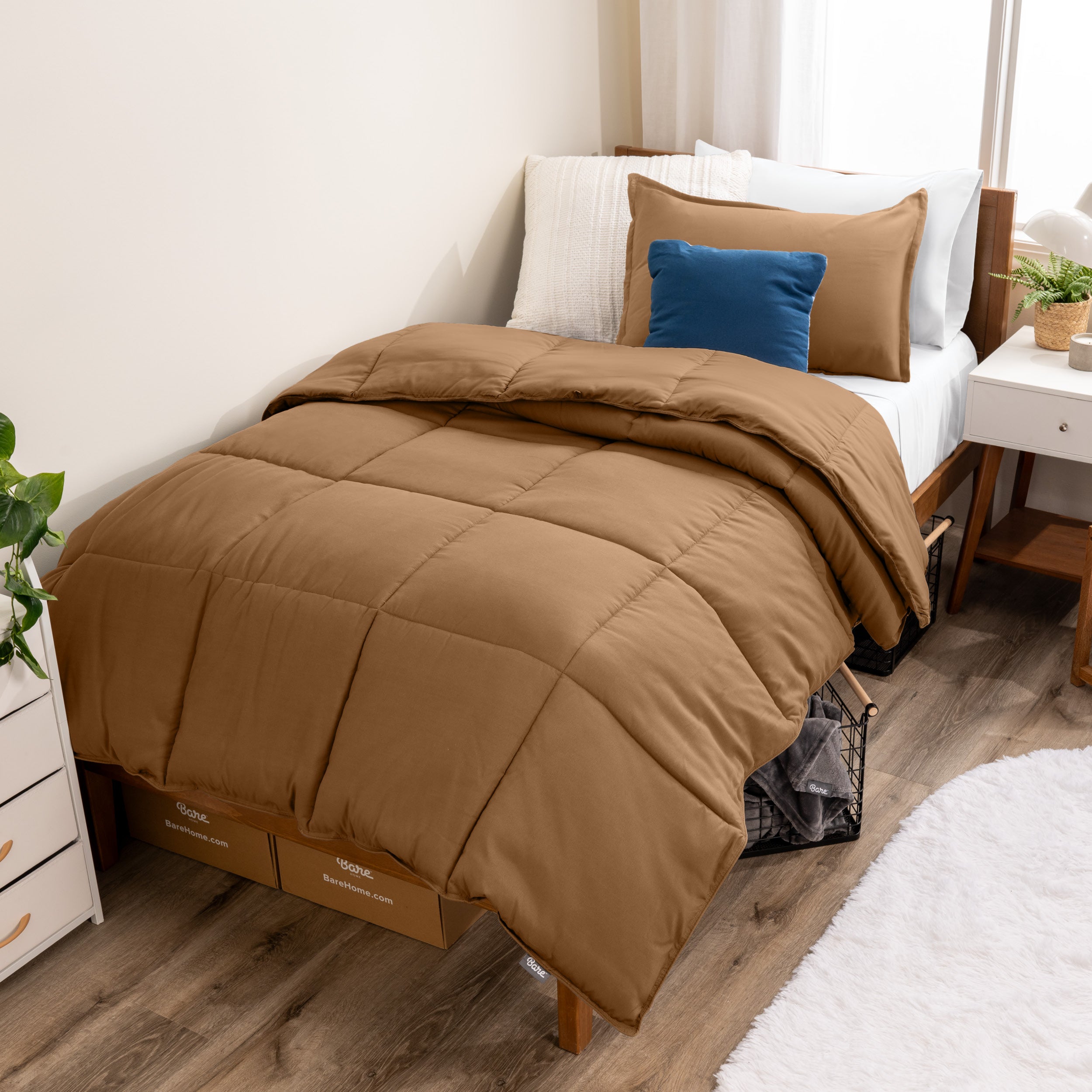 A modern bed with a down alternative comforter set on it