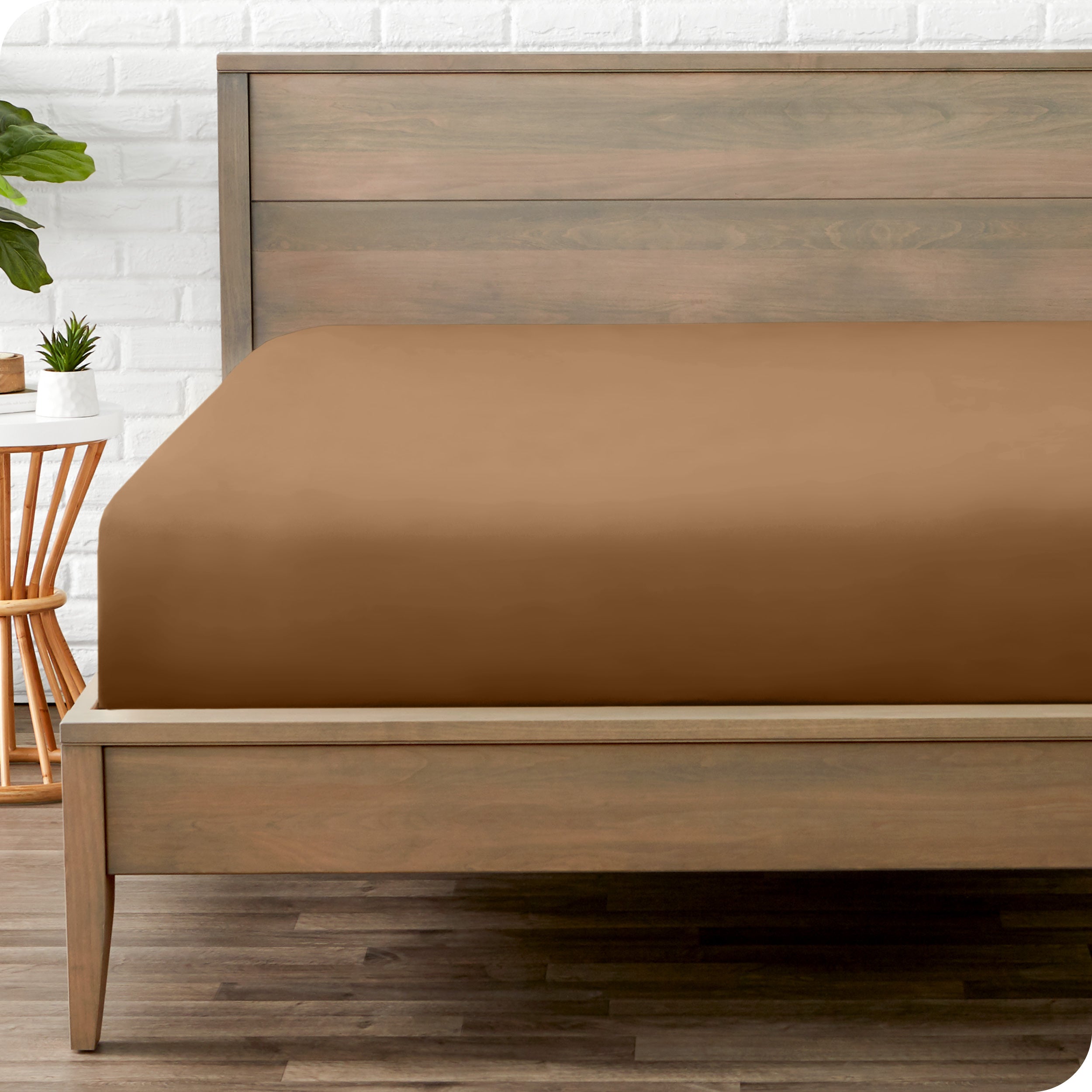 End of bed view with fitted sheet made on the mattress of a modern bed. 