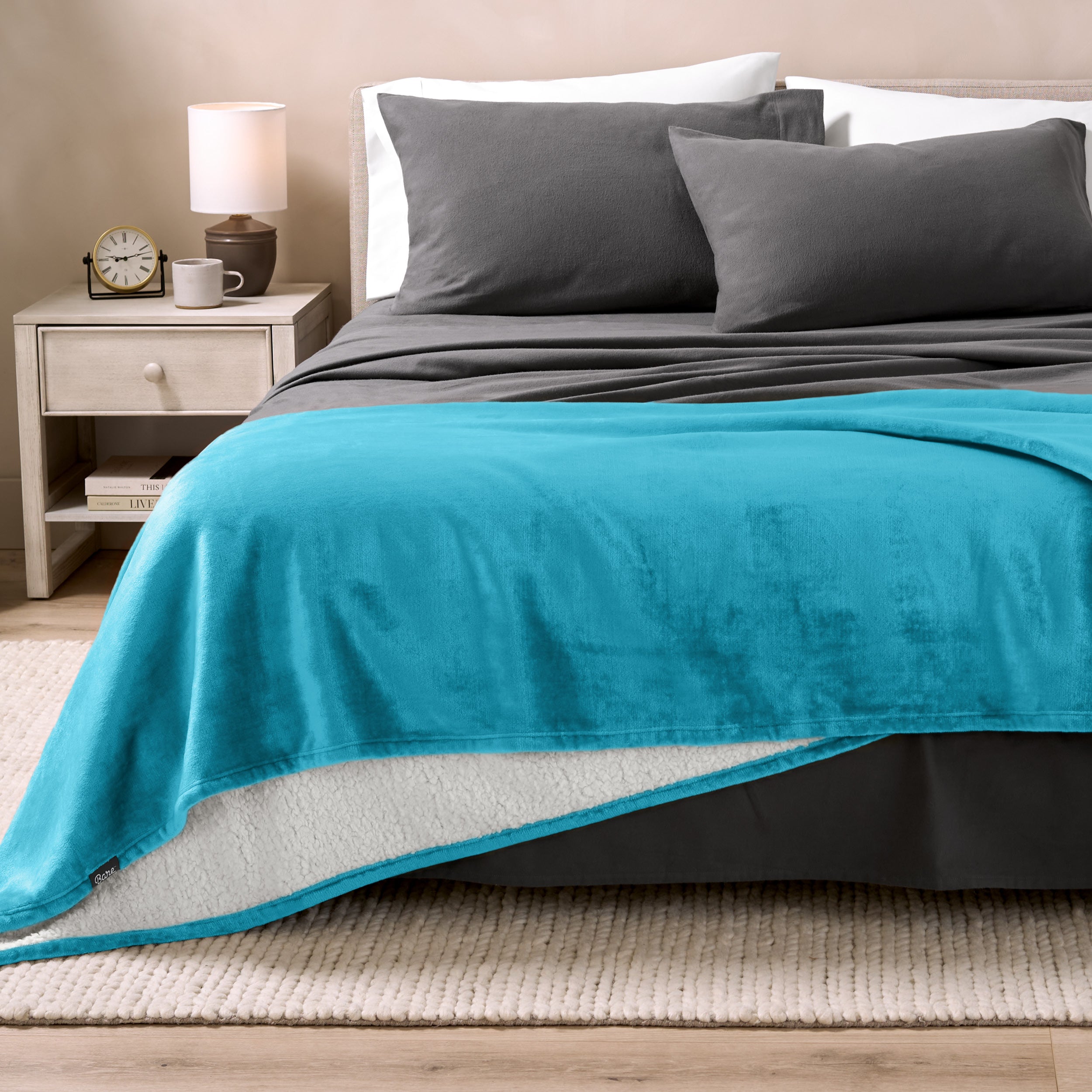 Sherpa Blanket laying on a bed folded over itself part way