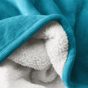 Close up of sherpa blanket showing texture of velvety soft side and sherpa backing