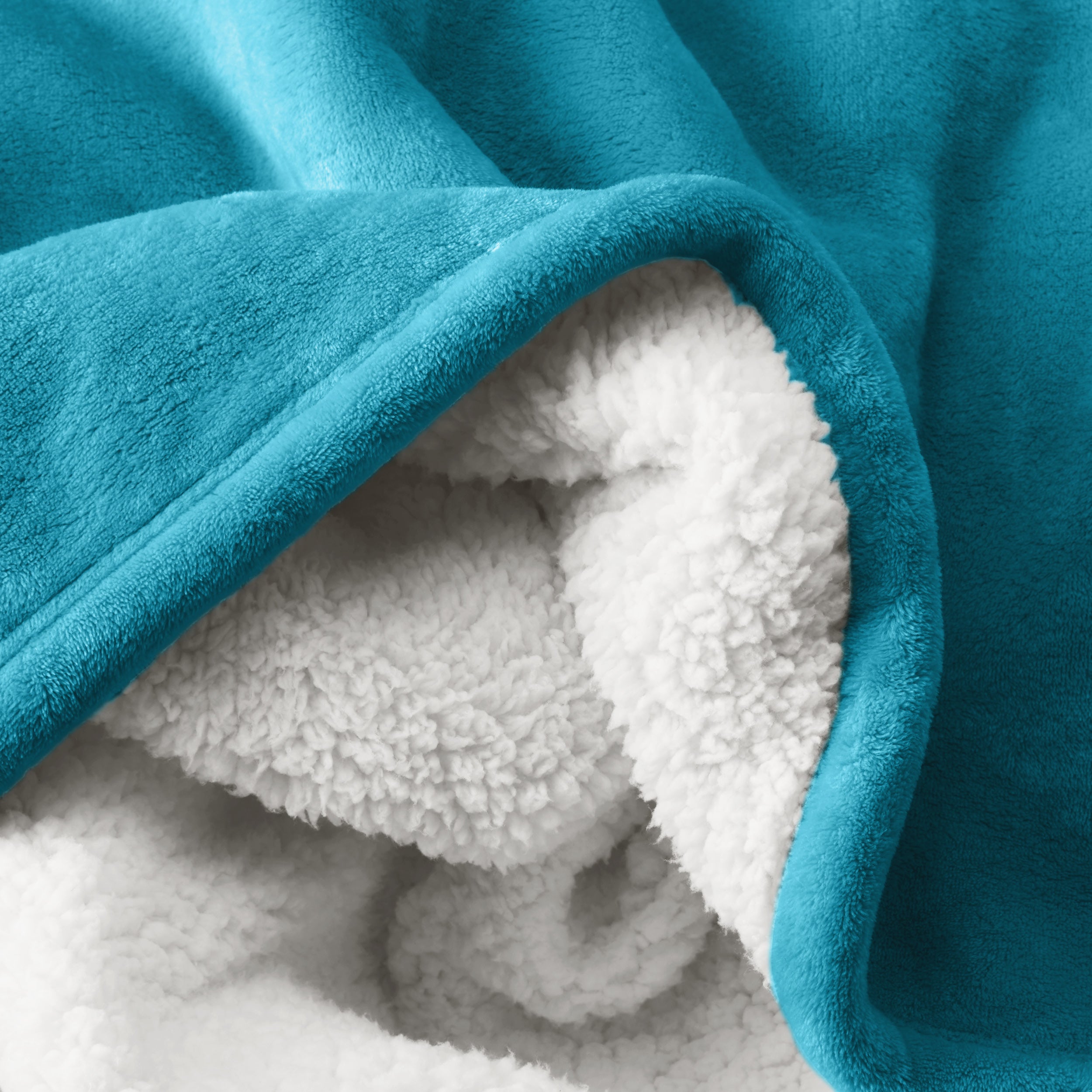 Close up of sherpa blanket showing texture of velvety soft side and sherpa backing
