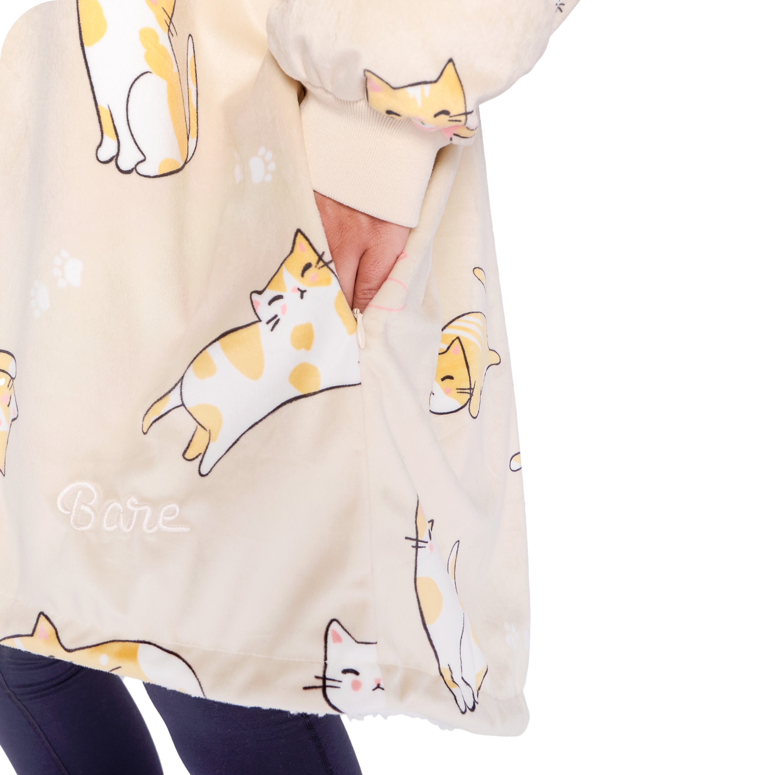 An adult with a hooded wearable blanket on