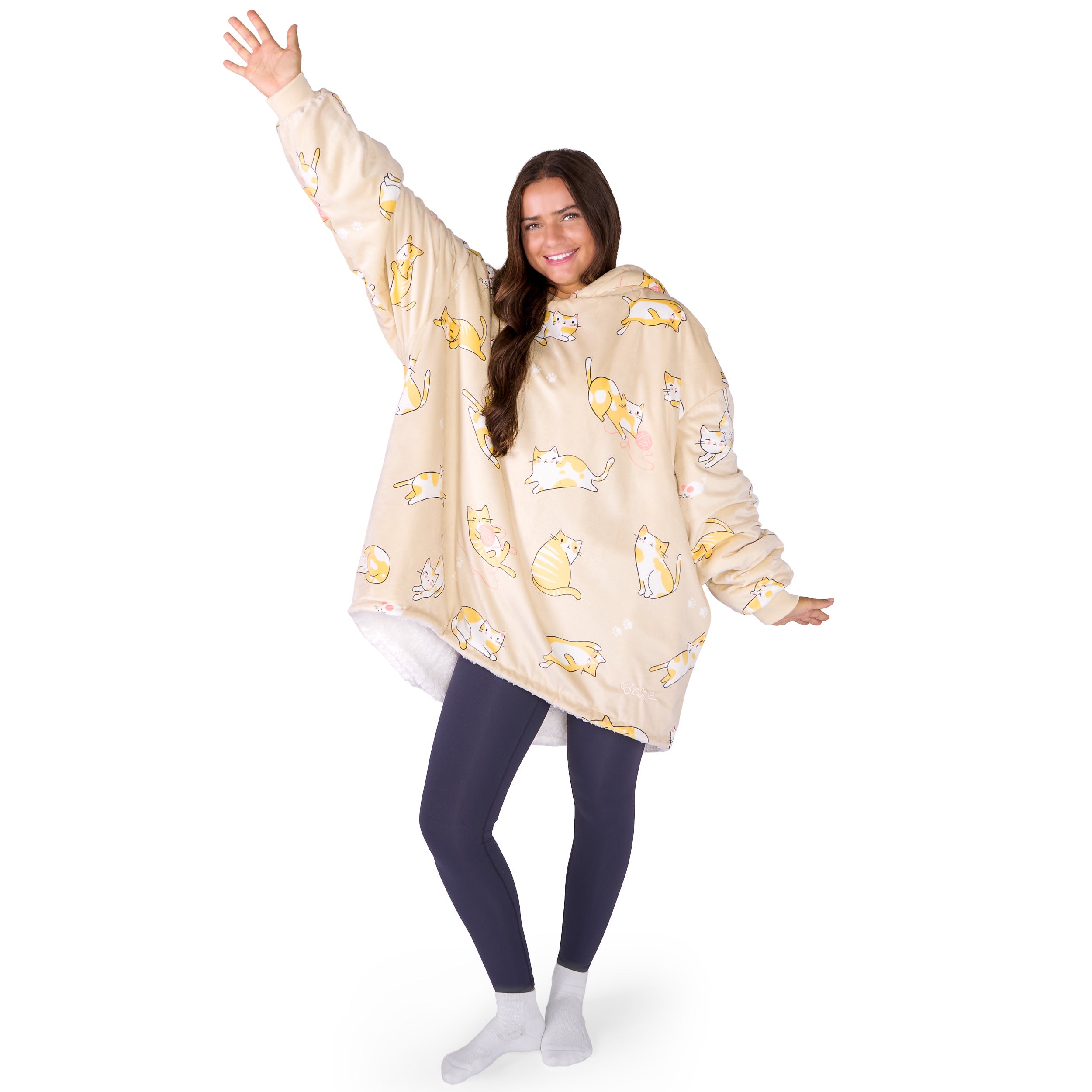 An adult with a hooded wearable blanket on