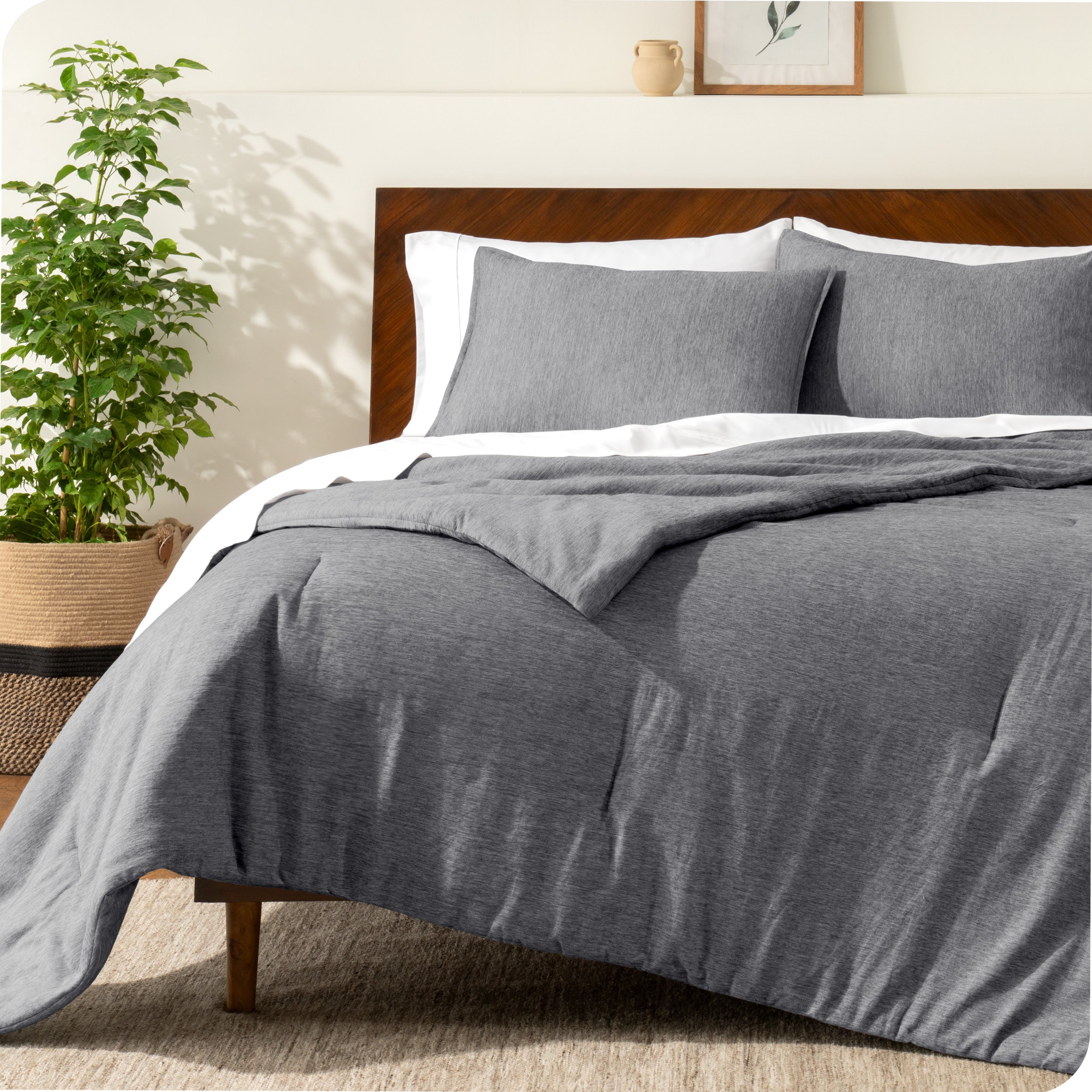 A modern bed with a down alternative comforter set on it
