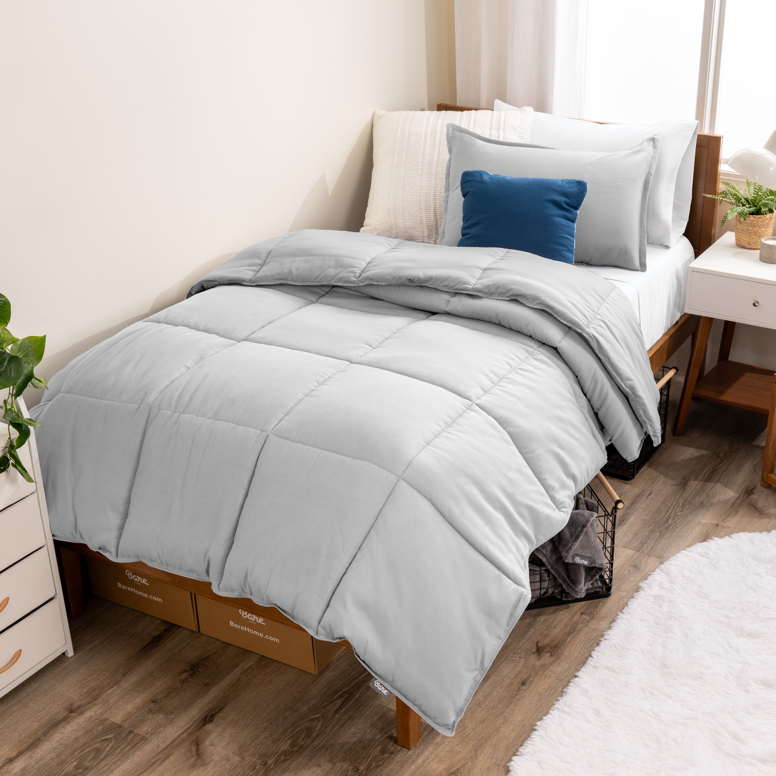 A modern bed with a down alternative comforter set on it