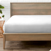 End of bed view with fitted sheet made on the mattress of a modern bed. 