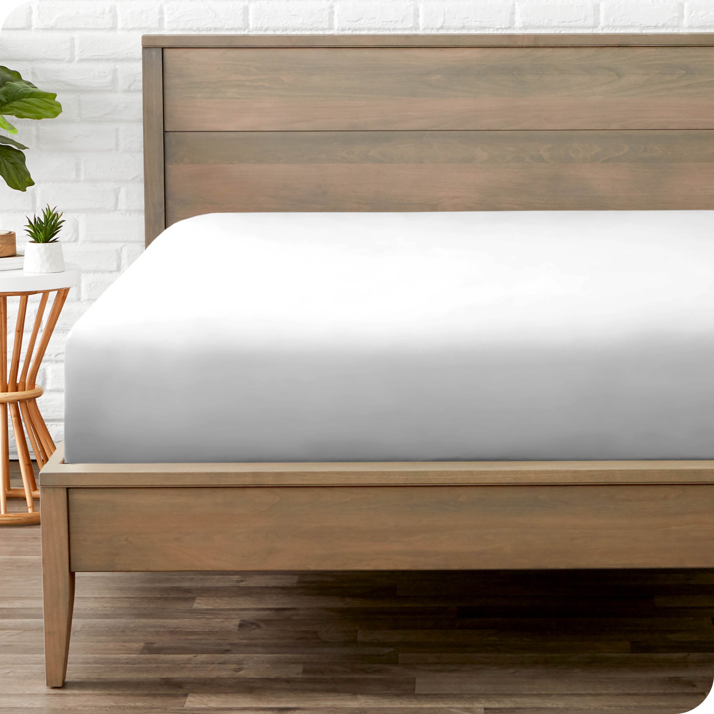 End of bed view with fitted sheet made on the mattress of a modern bed. 