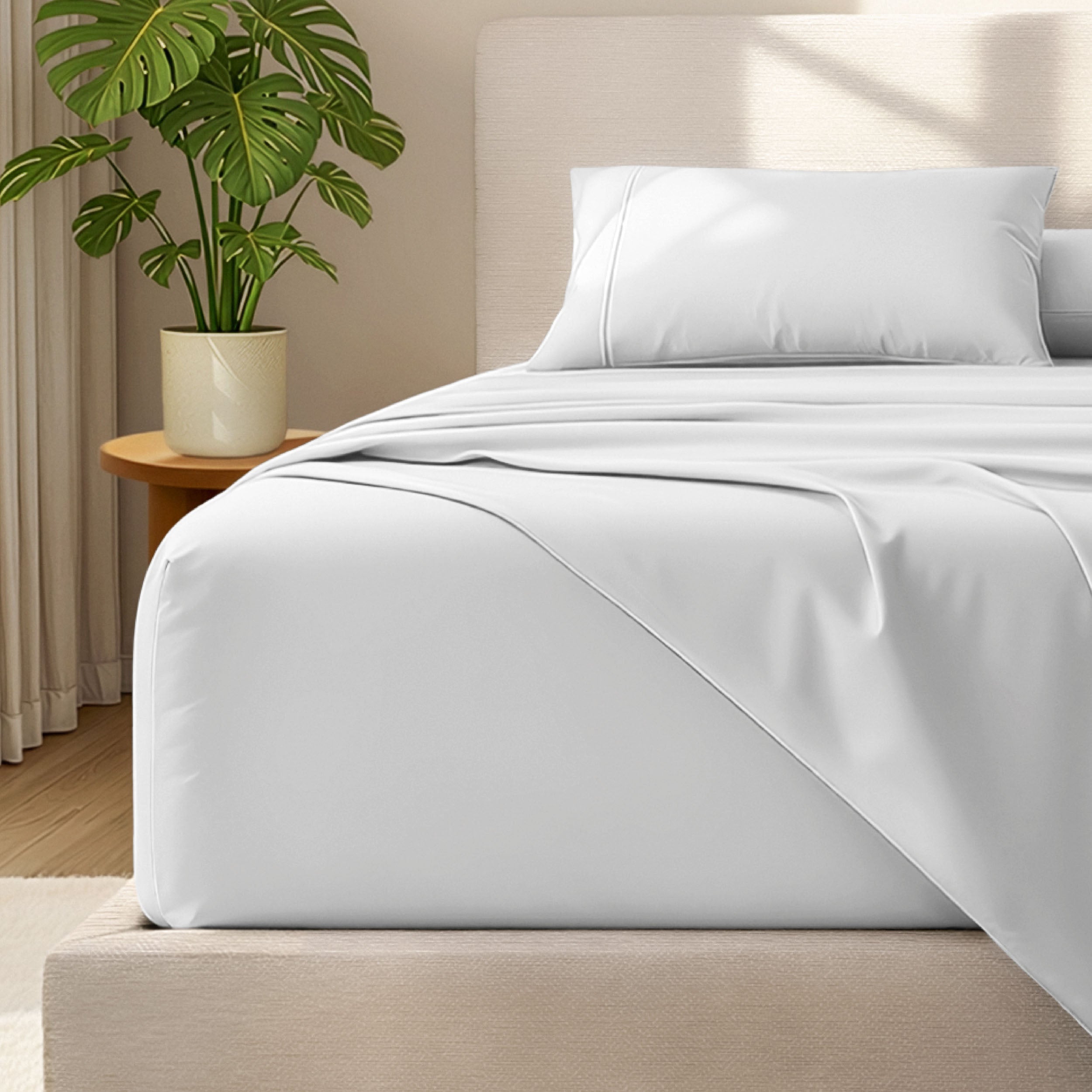 Microfiber bed sheets and pillowcases on a bed with a plant in the background