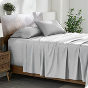 A cozy bedroom featuring a neatly made bed with soft, microfiber sheets