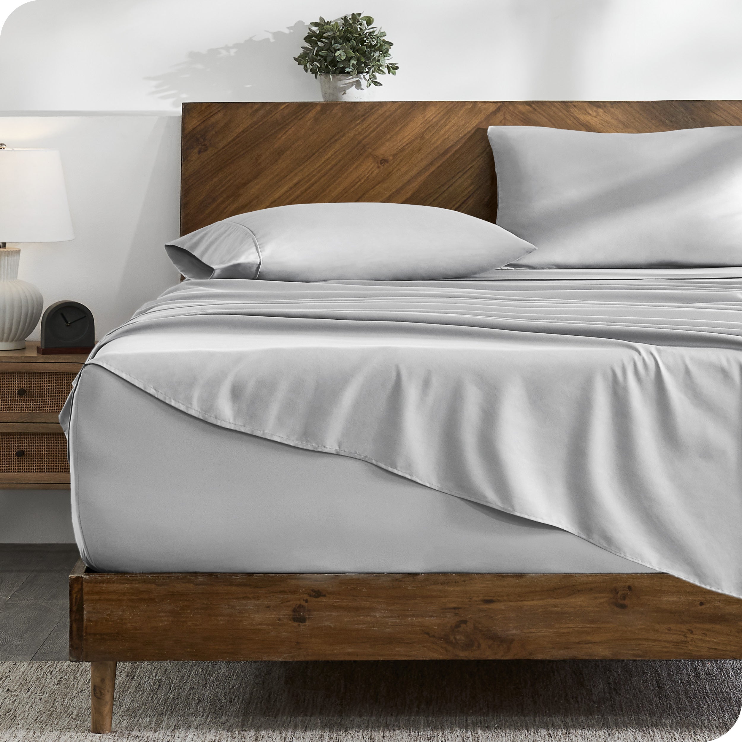 A cozy bedroom with a bed covered in soft microfiber sheets

