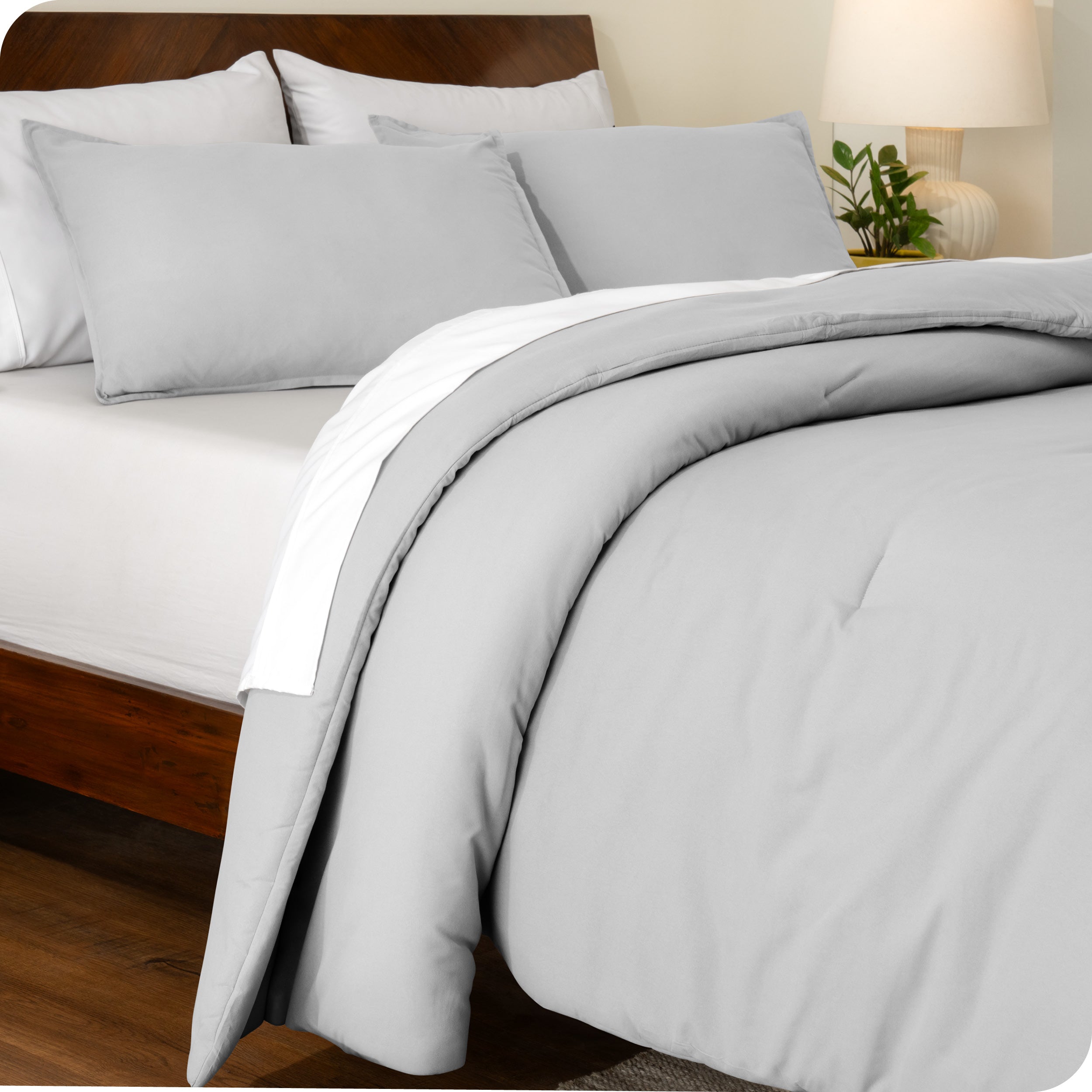 A side view of a bed made with a track stitch comforter set