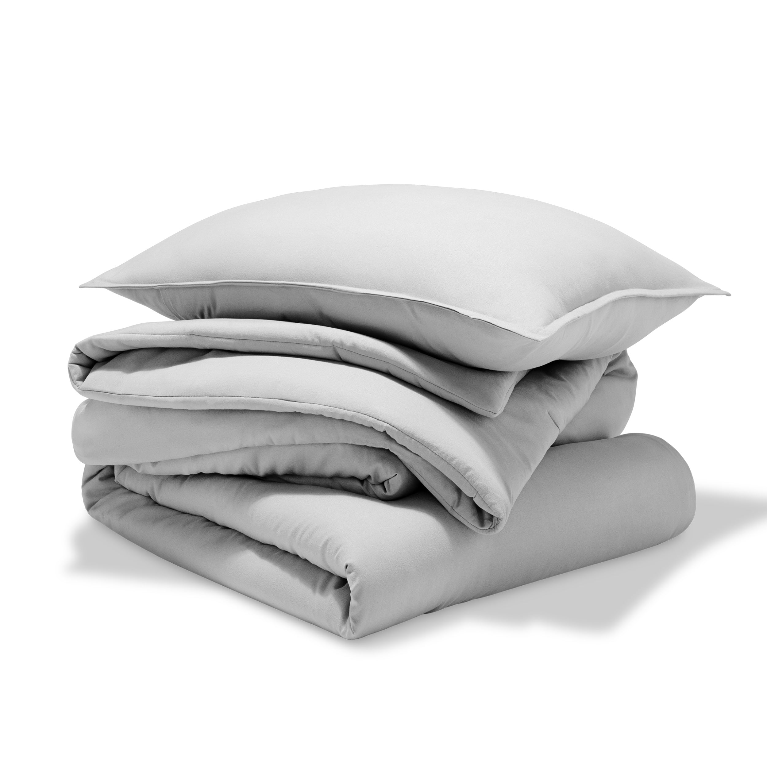 A comforter folded with a matching pillow sham stacked on top