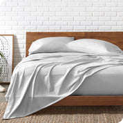 Organic jersey sheets on a bed with a wooden bed frame