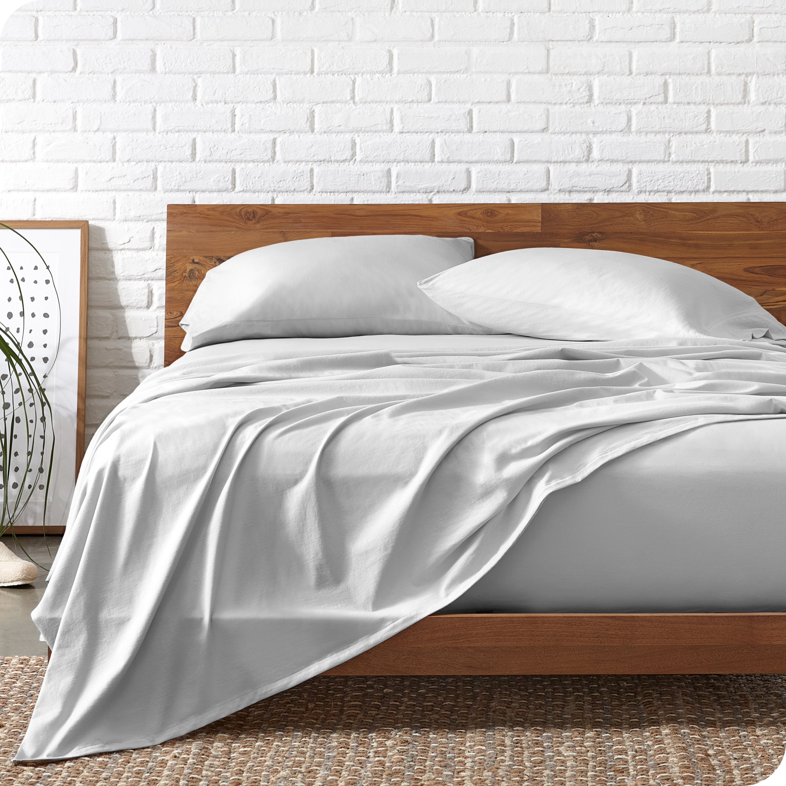 Organic jersey sheets on a bed with a wooden bed frame