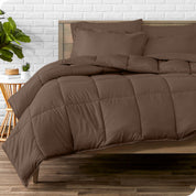 A wooden bed frame with sheets, pillow shams and a comforter on the bed