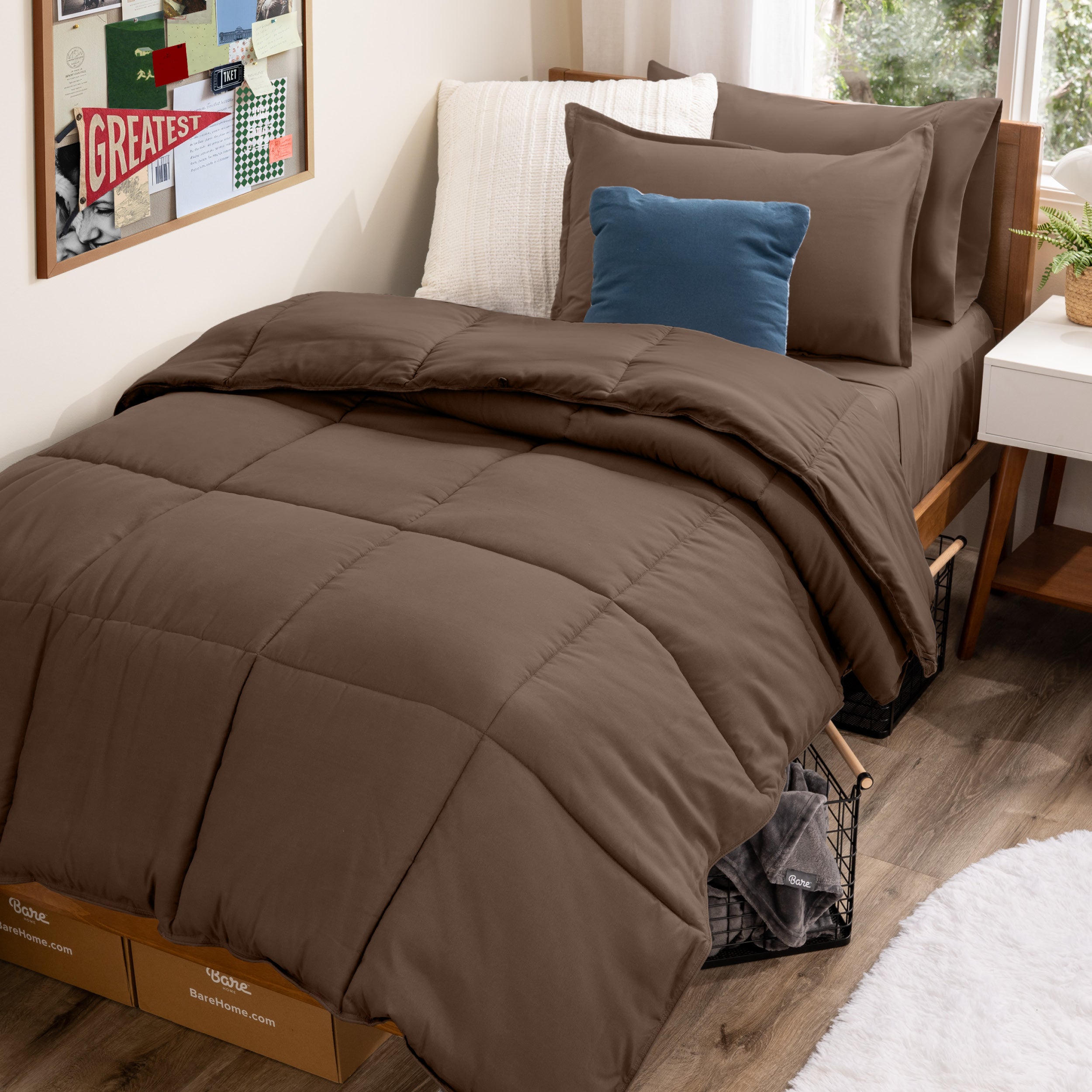 A college dorm room with a bed in a bag set on the mattress