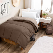 Wooden bed frame with a reversible comforter on the bed. The comforter is folded back over showing the two different colors.