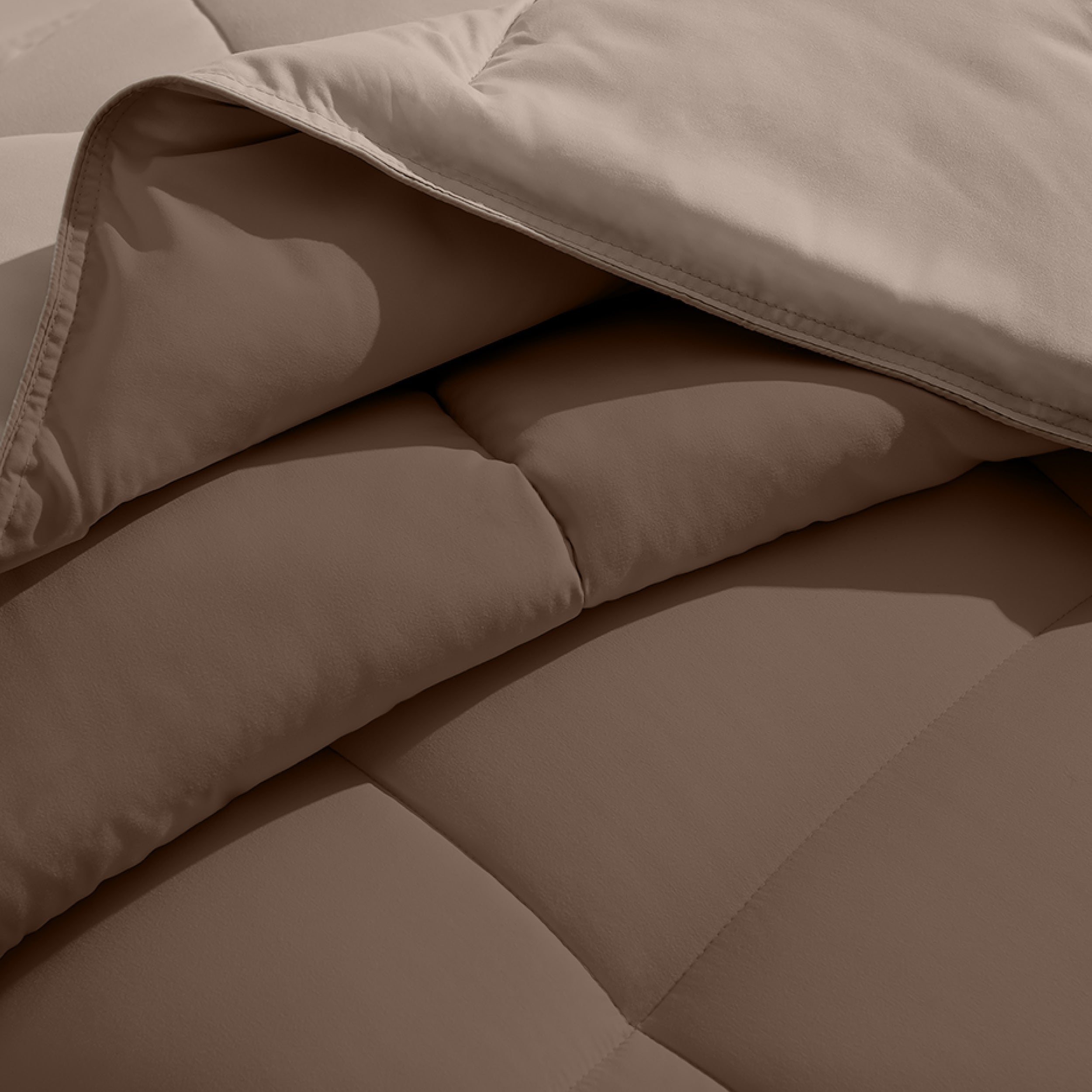 Close up of the comforter folded back showing the two different colored sides.