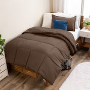 A modern bed with a down alternative comforter set on it