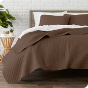 A quilted coverlet set on a bed