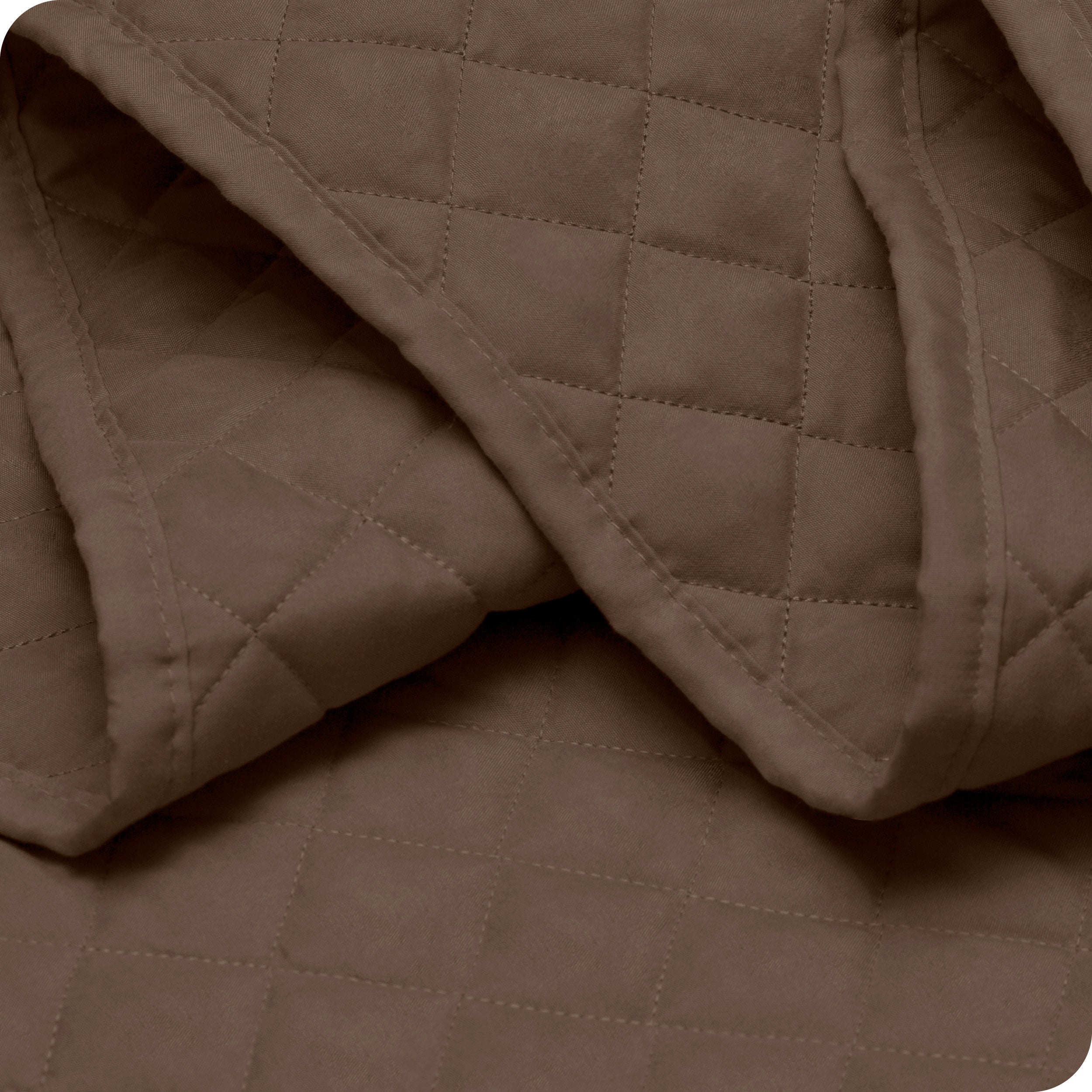 Close up of a coverlet showing the stitching