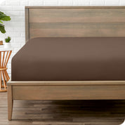 End of bed view with fitted sheet made on the mattress of a modern bed. 