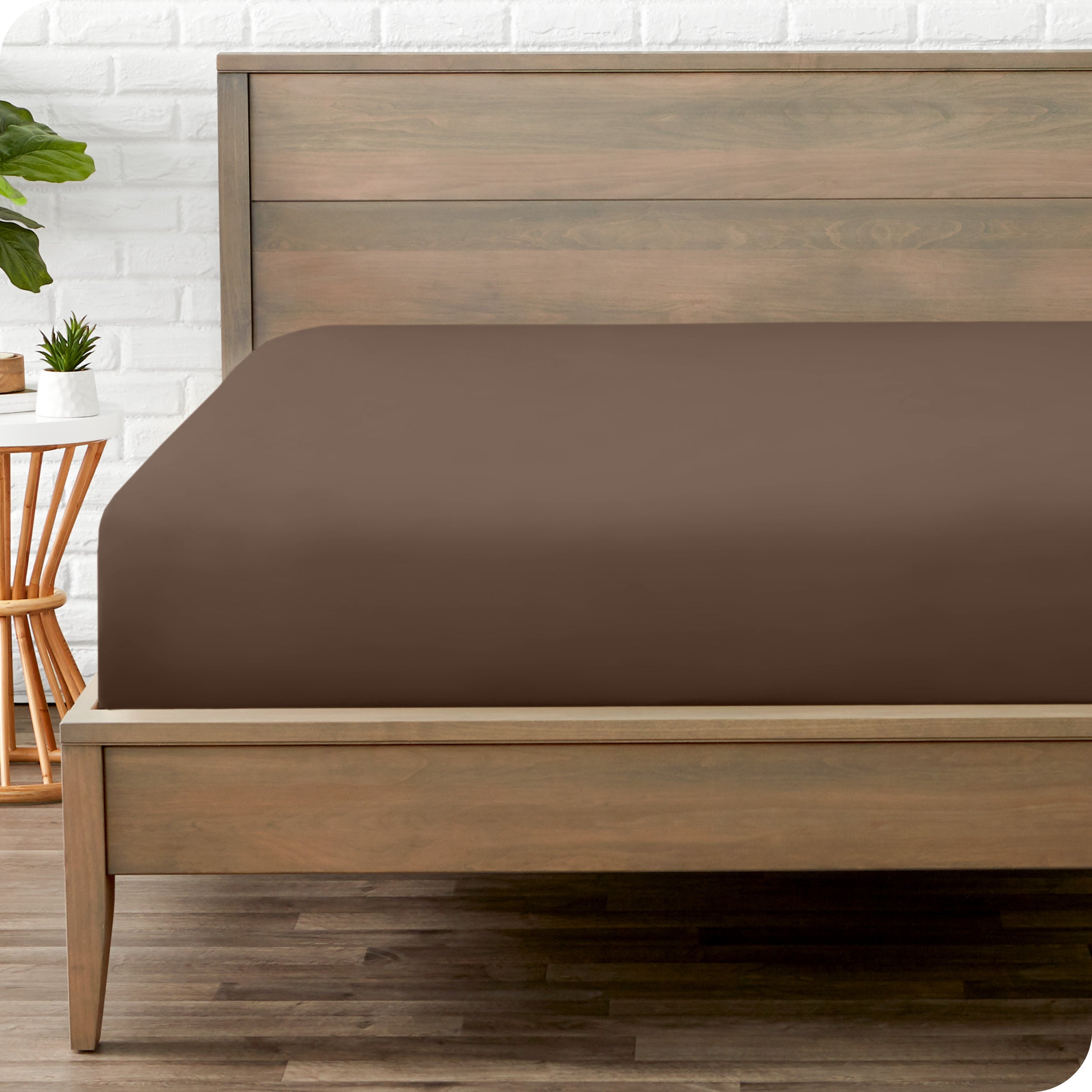 End of bed view with fitted sheet made on the mattress of a modern bed. 