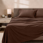 View of fleece sheets from the end of a bed with the top sheet draped over the side and end