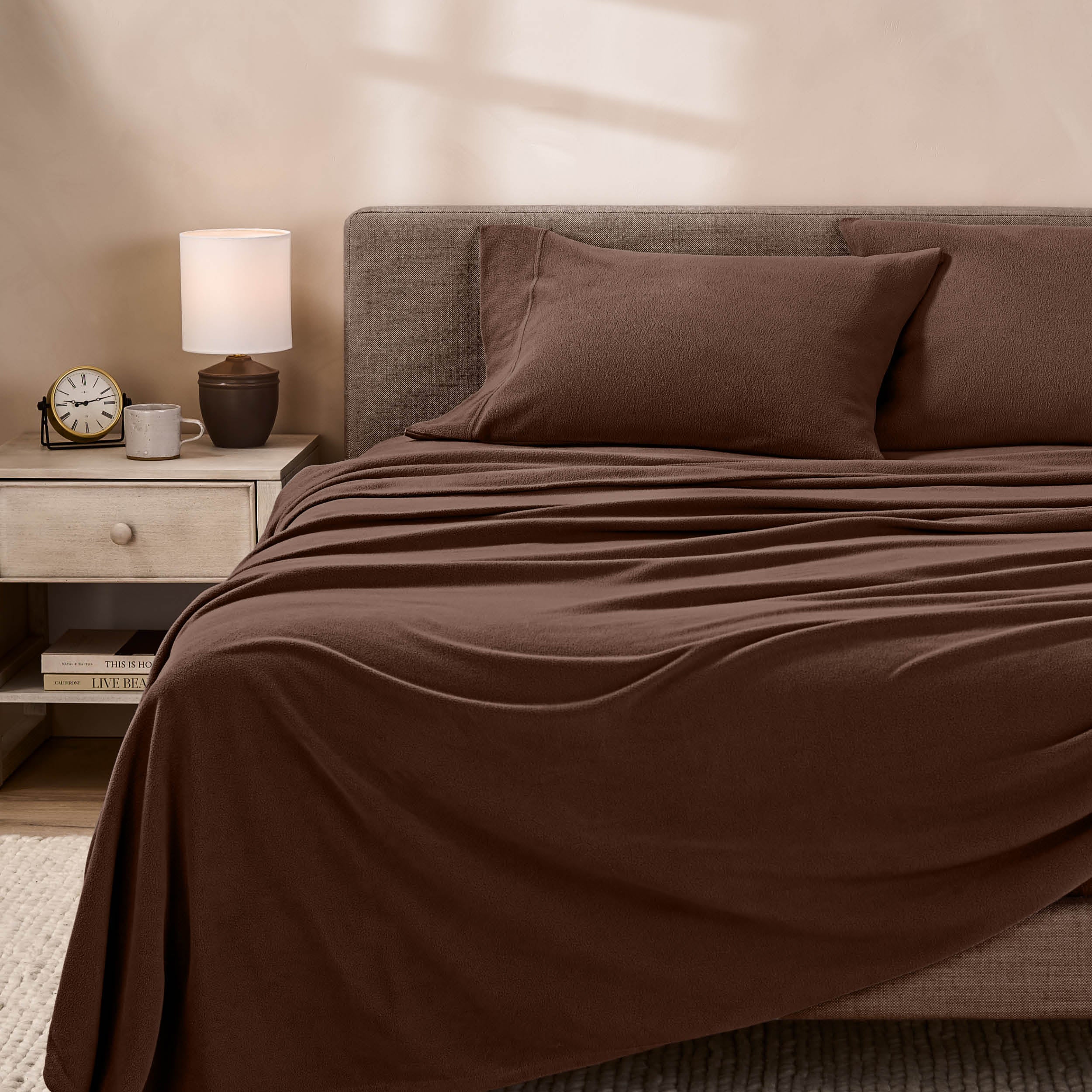 View of fleece sheets from the end of a bed with the top sheet draped over the side and end