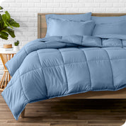 A wooden bed frame with sheets, pillow shams and a comforter on the bed