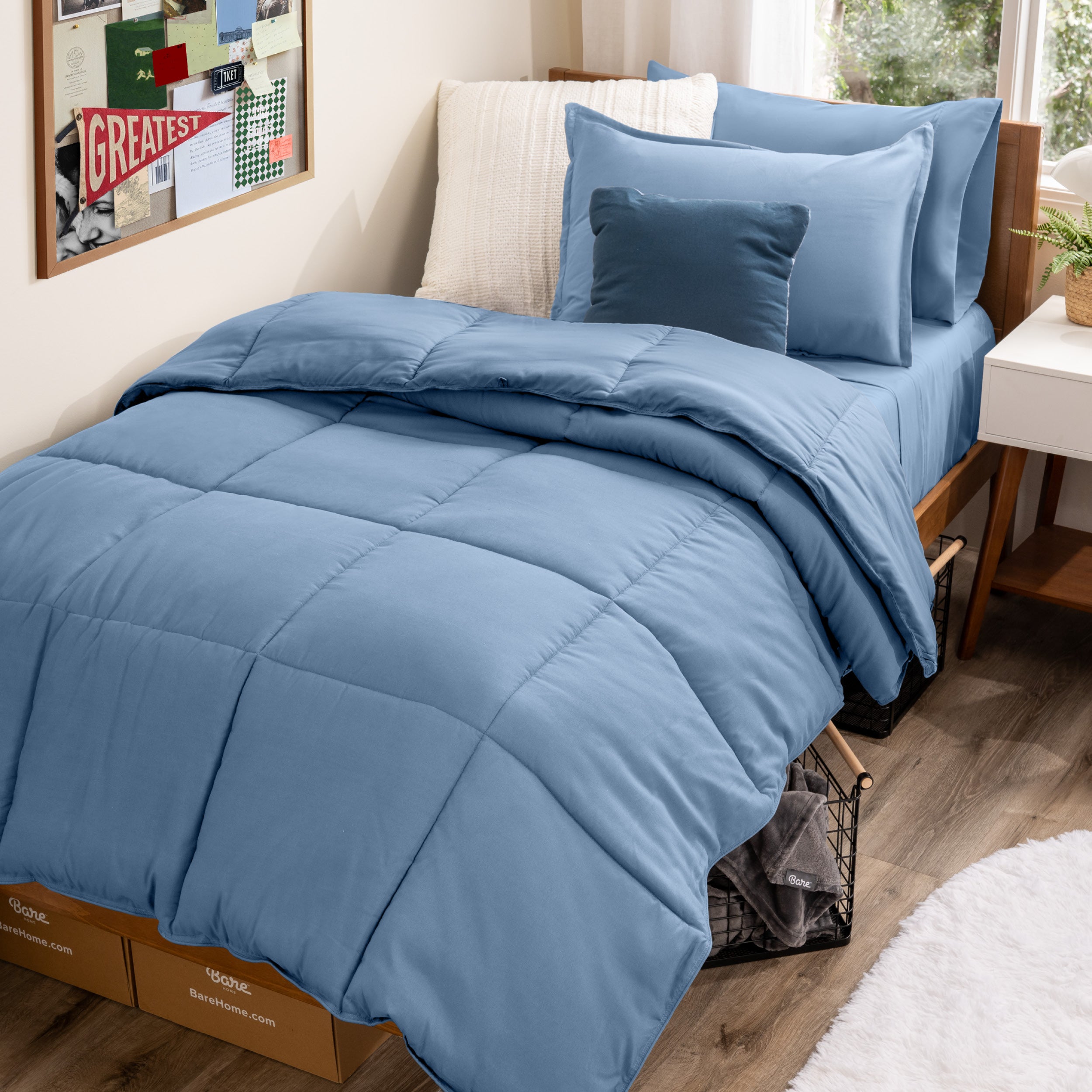 A college dorm room with a bed in a bag set on the mattress